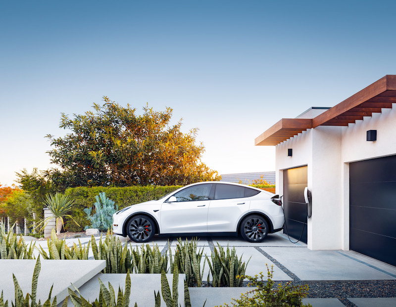 Tesla's Model Y EV Charging outside the homeowner's garage using EV Chargers