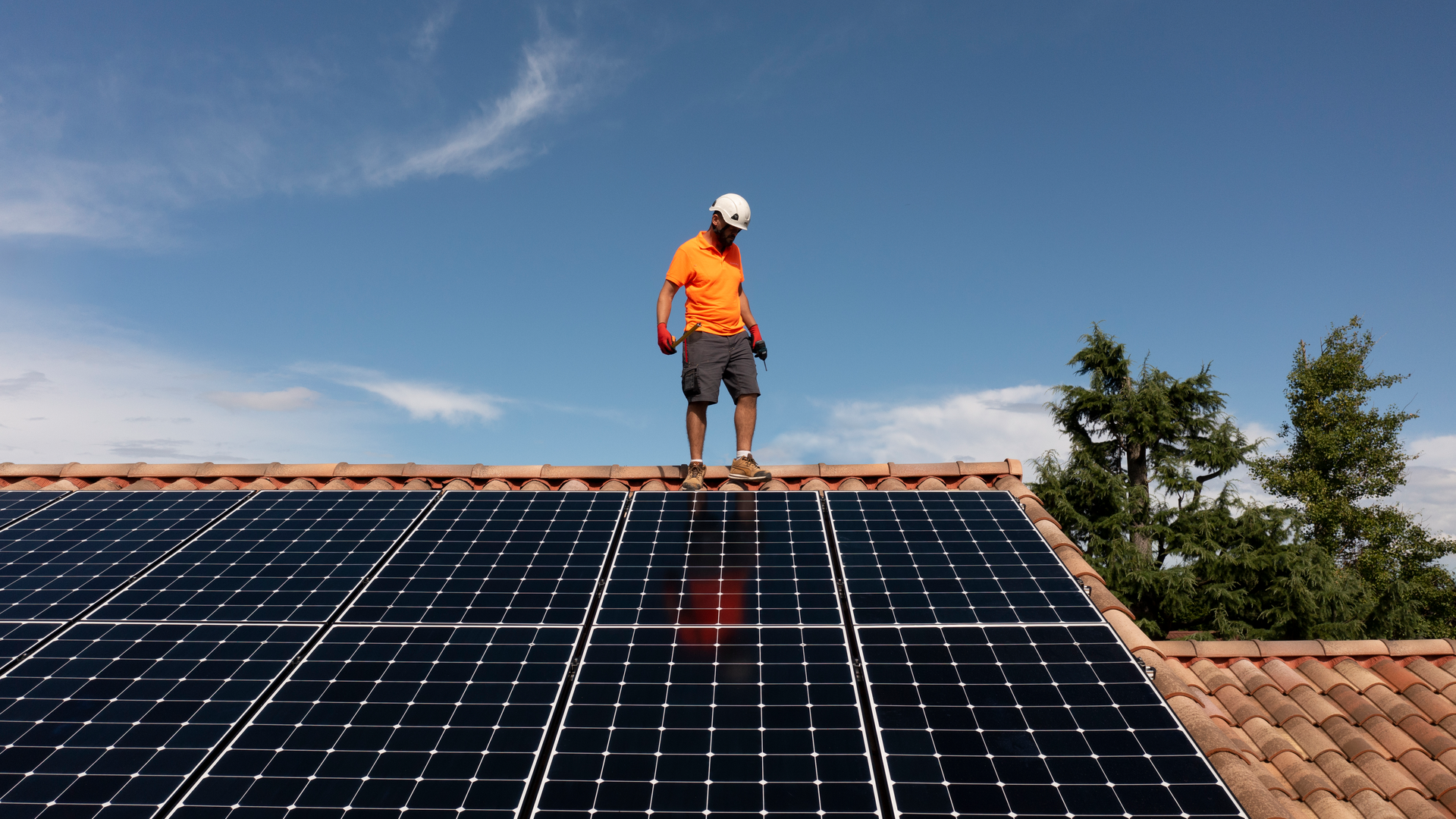 Installer Standing on the roof whilst installing solar panels