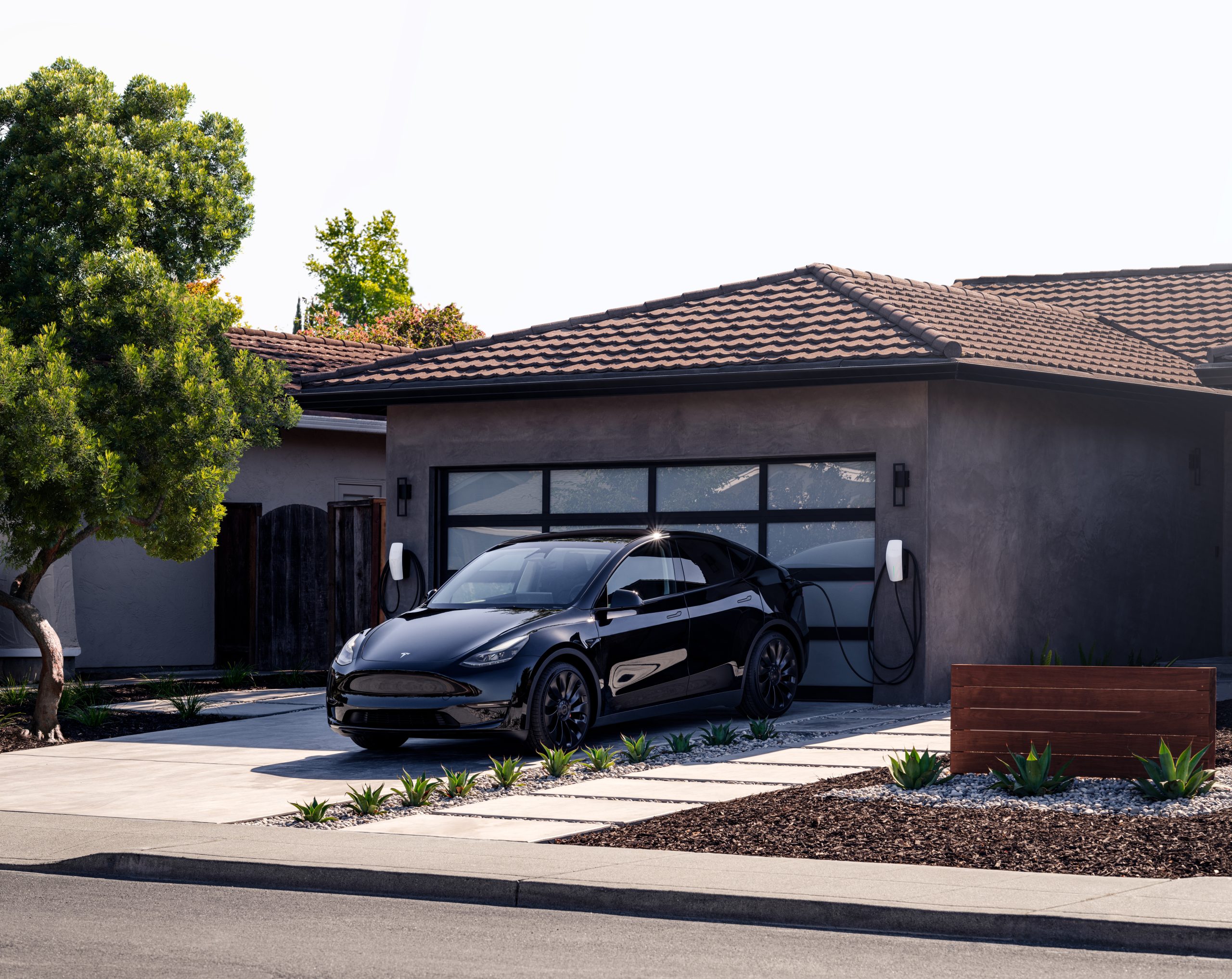 Image of a Tesla Car charging at an all electric home
