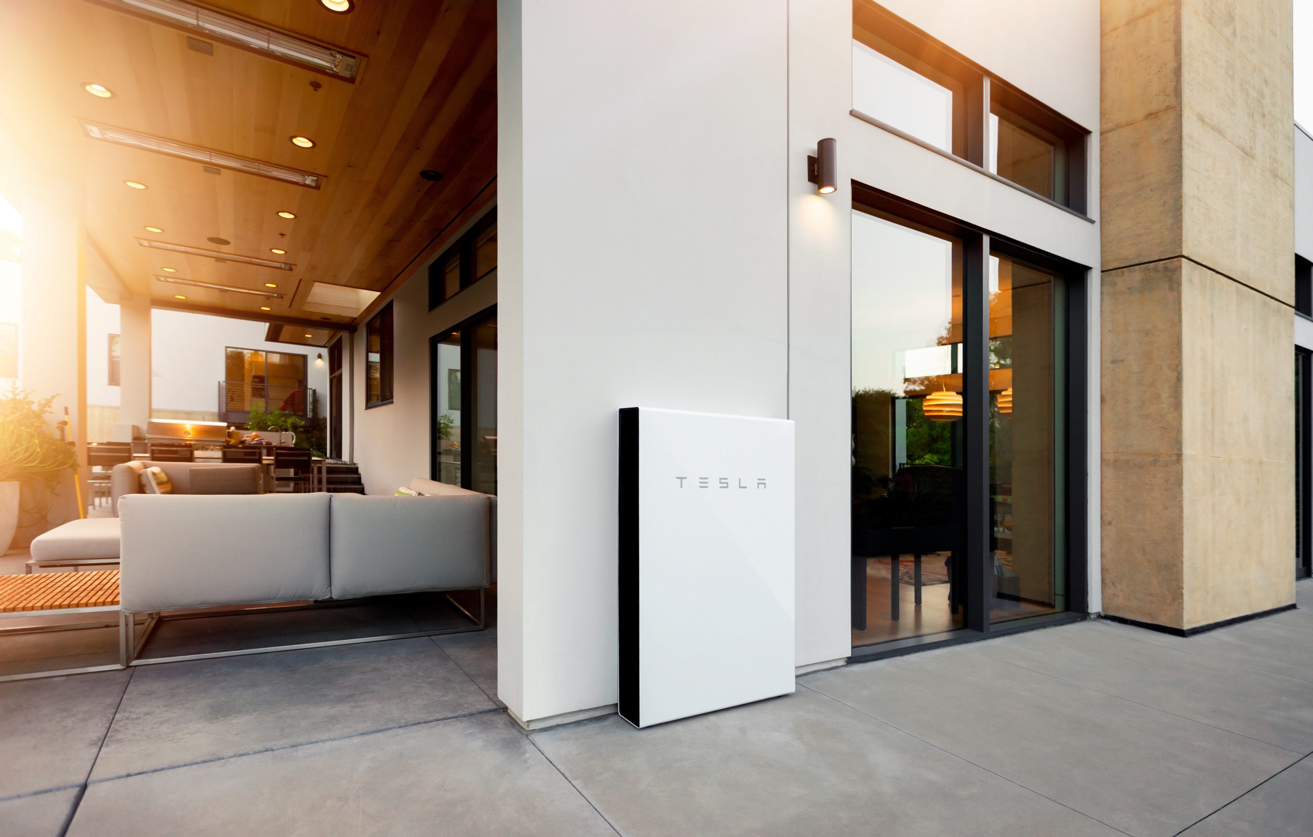 home battery storage tesla powerwall installed on an exterior wall